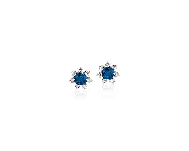 Each of these eye-catching 14k white gold stud earrings feature a single sapphire surrounded by a blossom halo of brilliant diamonds for a look that’s both colorful and chic.