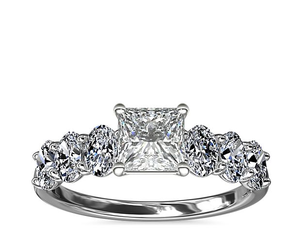 Love shines bright in this beautiful platinum and diamond engagement ring. Beset with a row of sparkling oval diamonds this design will showcase your choice of center beautifully,