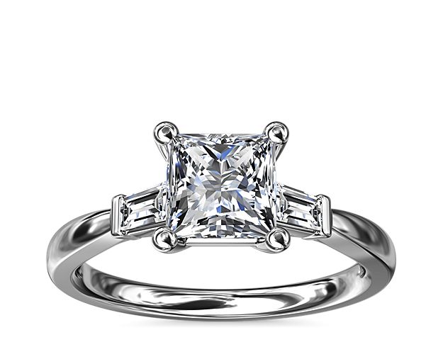 Classic and timeless, this engagement ring features two dazzling tapered baguettes that frame your choice of center stone beautifully.