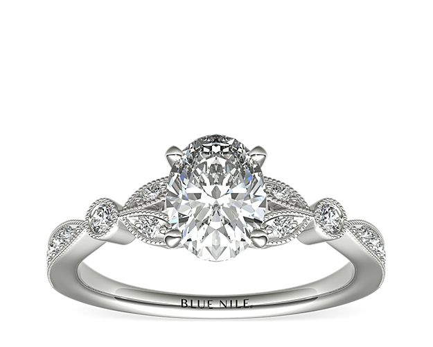 Vintage-inspired, this delicate 14k white gold engagement ring features pavé-set round diamonds surrounded by a milgrain edge.