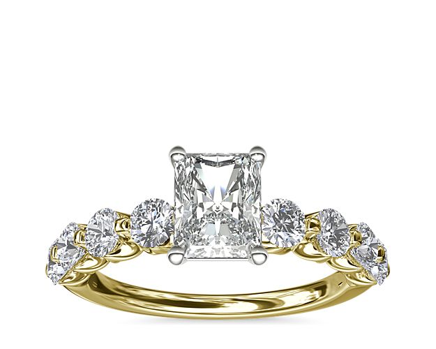 A floating center stone summons the eye to this decadent engagement ring, while eight round accent diamonds form a breathtaking backdrop. The 14k yellow gold setting brings luxurious warmth to this classic ring.