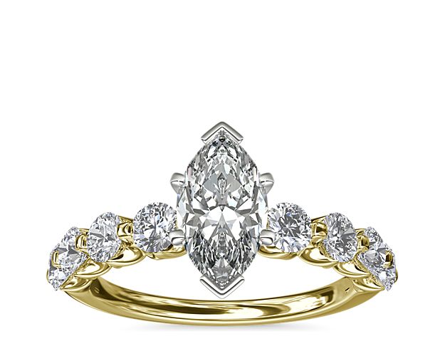 A floating center stone summons the eye to this decadent engagement ring, while eight round accent diamonds form a breathtaking backdrop. The 14k yellow gold setting brings luxurious warmth to this classic ring.