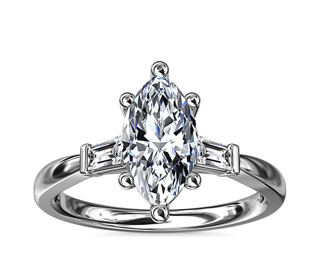 Classic and timeless, this engagement ring features two dazzling tapered baguettes that frame your choice of center stone beautifully.