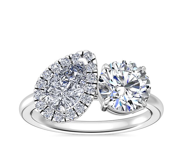 Go for a unique engagement ring with this two-stone design featuring a brightly sparkling pear-cut diamond accented by a brilliant halo and your own chosen round, princess, asscher, emerald-cut, radiant, or cushion diamond. It is beautifully designed in timeless platinum for everlasting quality.