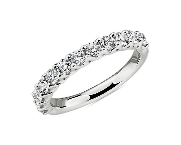 A divine tessere weave lets light flood into 12 round diamonds highlighting the sophisticated dazzle of this platinum wedding ring whether worn on its own or stacked next to an art deco-inspired engagement ring.